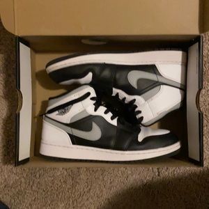 Black and white jordans mid 1s